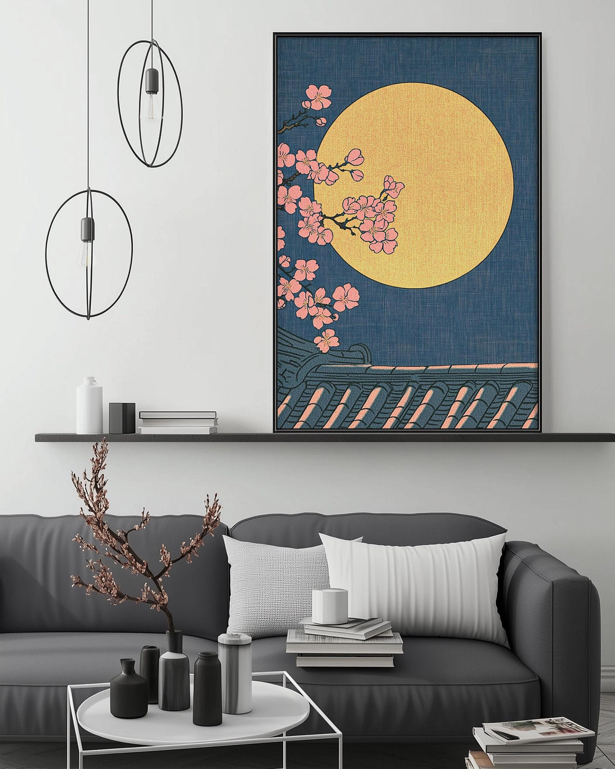 a modern living room with a gray sofa, a coffee table, and a large framed artwork depicting a cherry blossom tree with pink flowers against a yellow background.