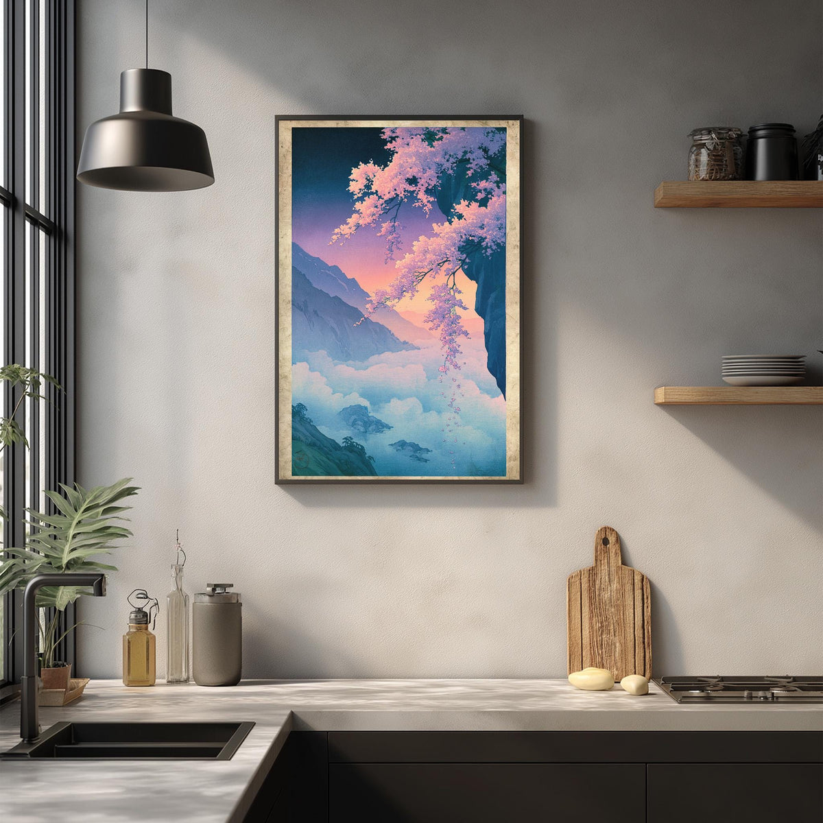 a kitchen counter with a framed painting of a mountain landscape hanging above it. The painting has a vibrant color palette, with shades of blue, pink, and green. The kitchen counter also has various items on it, including a cutting board, a bottle, and a vase.