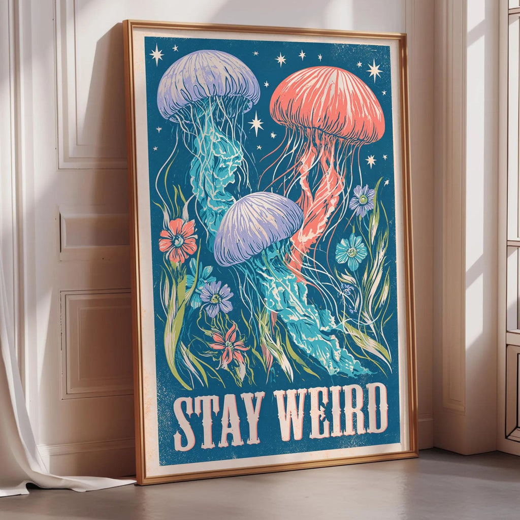 A framed poster with a vibrant illustration of colorful jellyfish and flowers, along with the text "STAY WEIRD" displayed prominently.