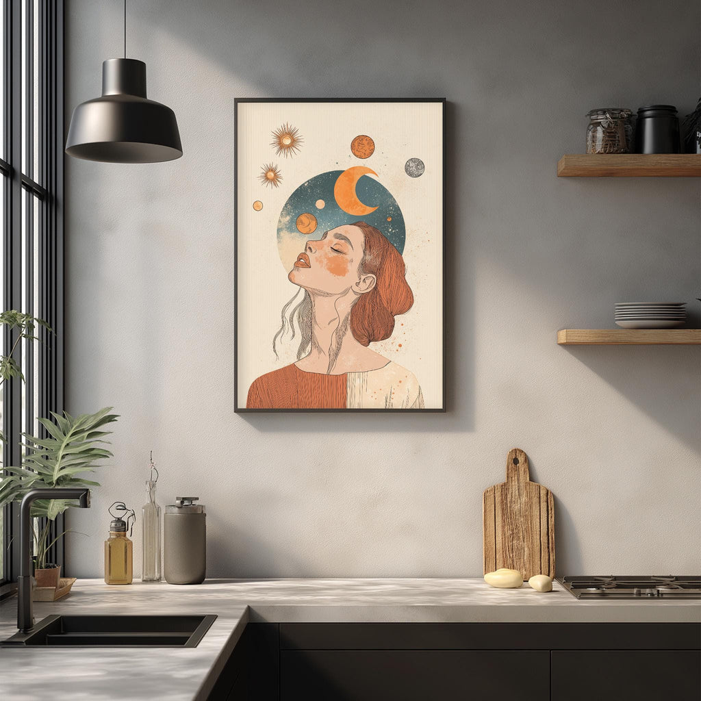 a framed illustration of a woman with a crescent moon and sun on her head, hanging on a wall above a kitchen counter.