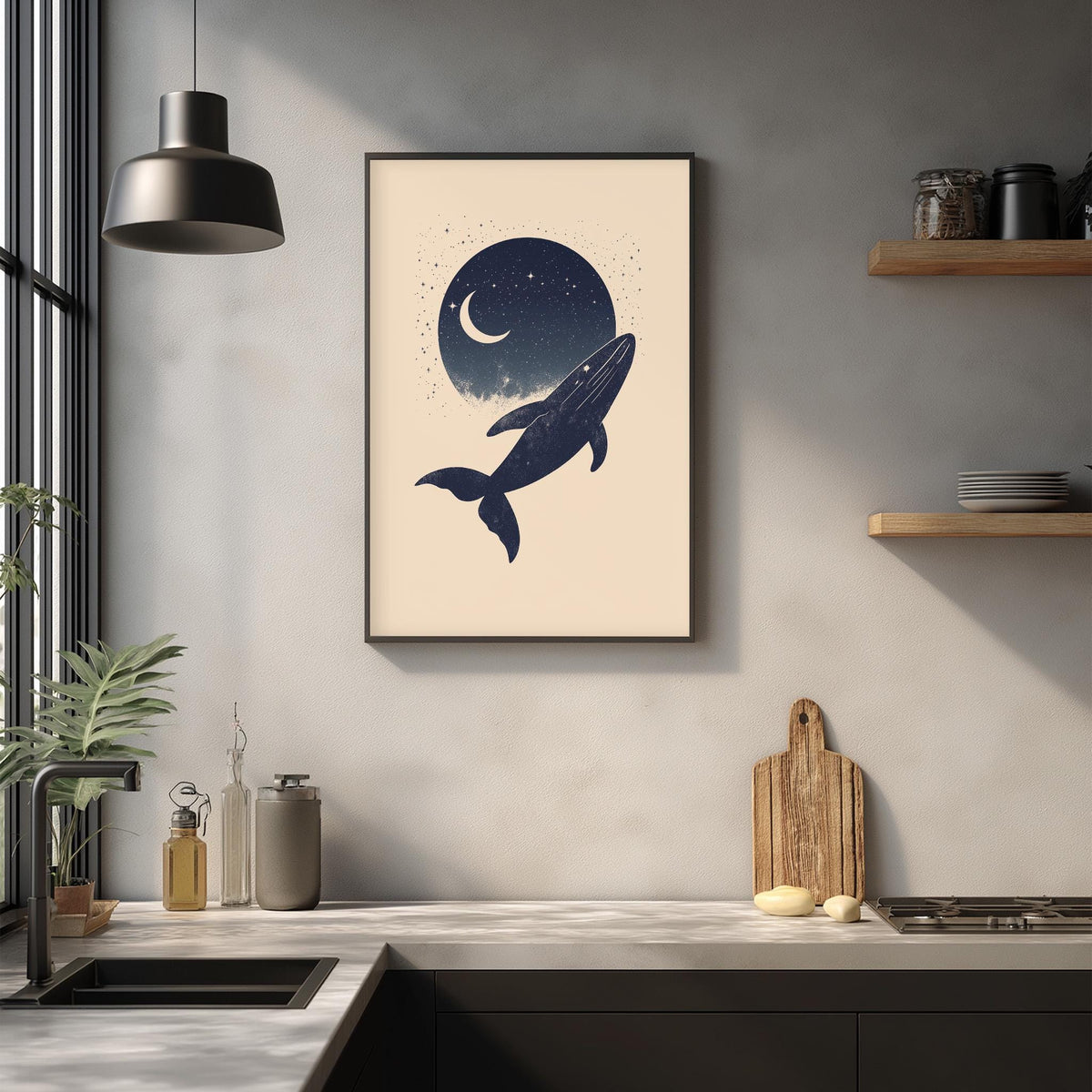 a framed artwork of a whale against a night sky with a crescent moon, hanging on a wall above a kitchen counter with various kitchen items and decor.