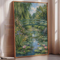 A framed painting depicting a serene pond with a green bridge and lush vegetation in the background.