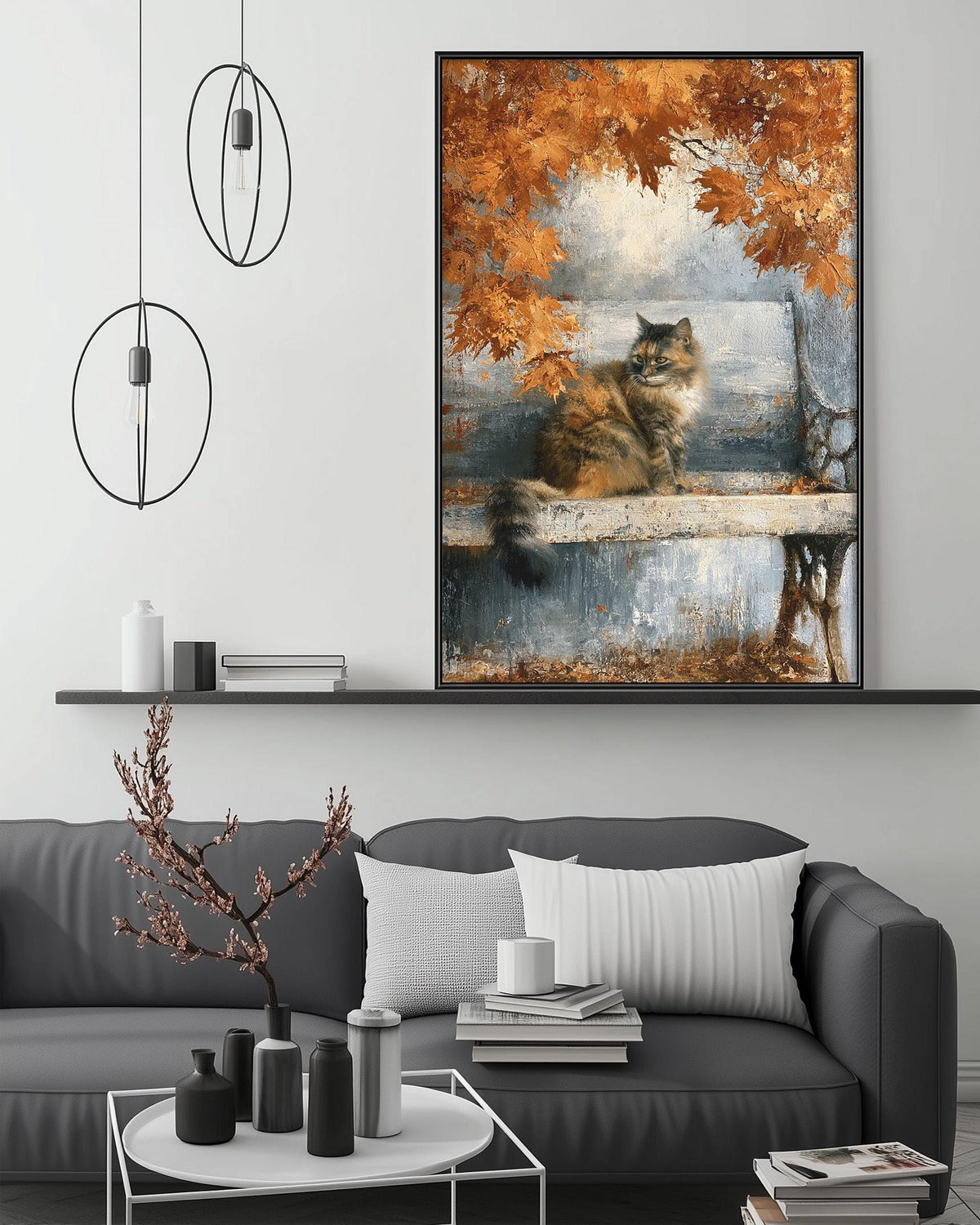 a large painting of a cat sitting on a bench, surrounded by autumn leaves, hanging on a wall above a gray couch with white pillows.