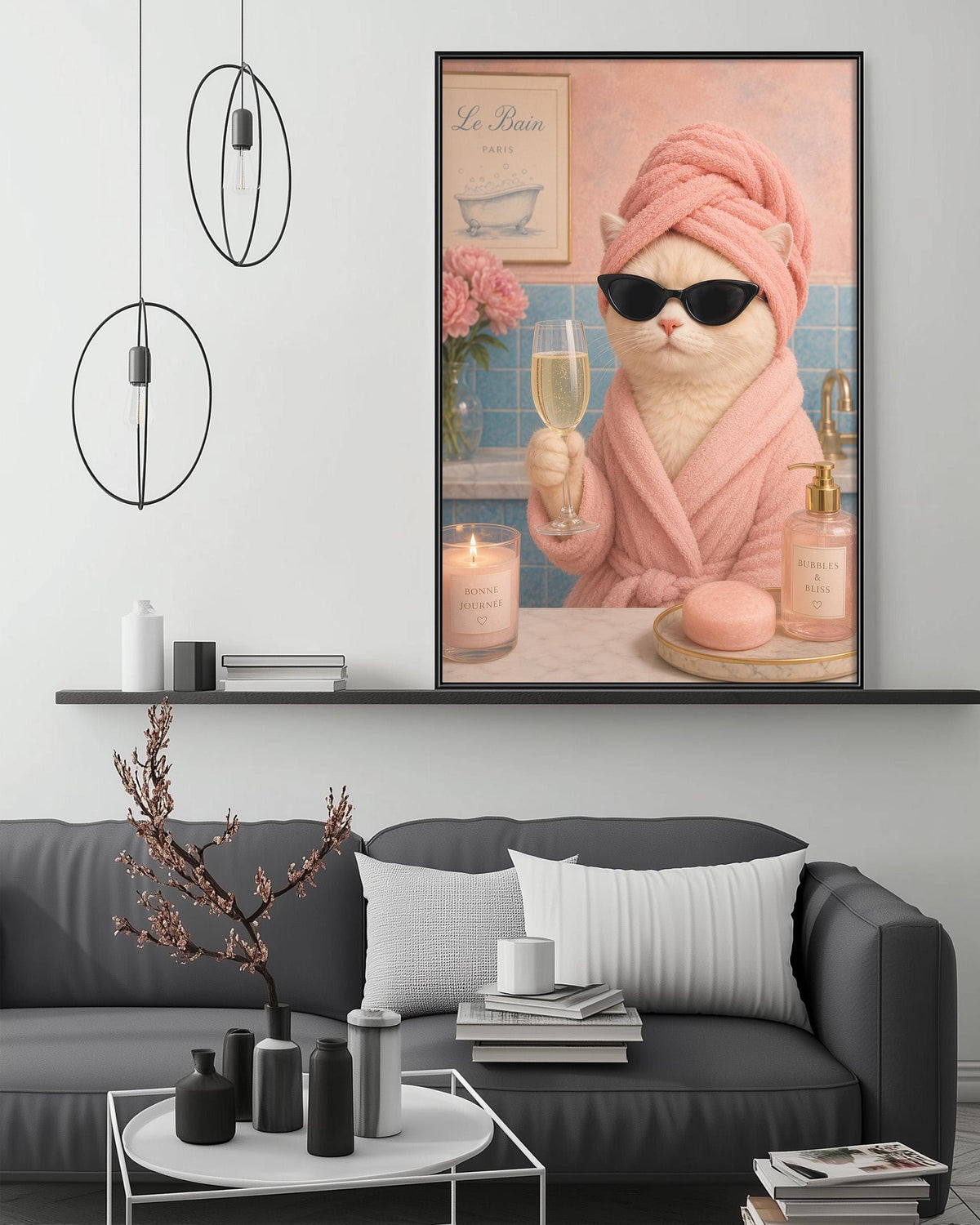 A cozy living room with a gray sofa, a coffee table, and a framed poster of a cat wearing a pink bathrobe and sunglasses, holding a glass of wine.