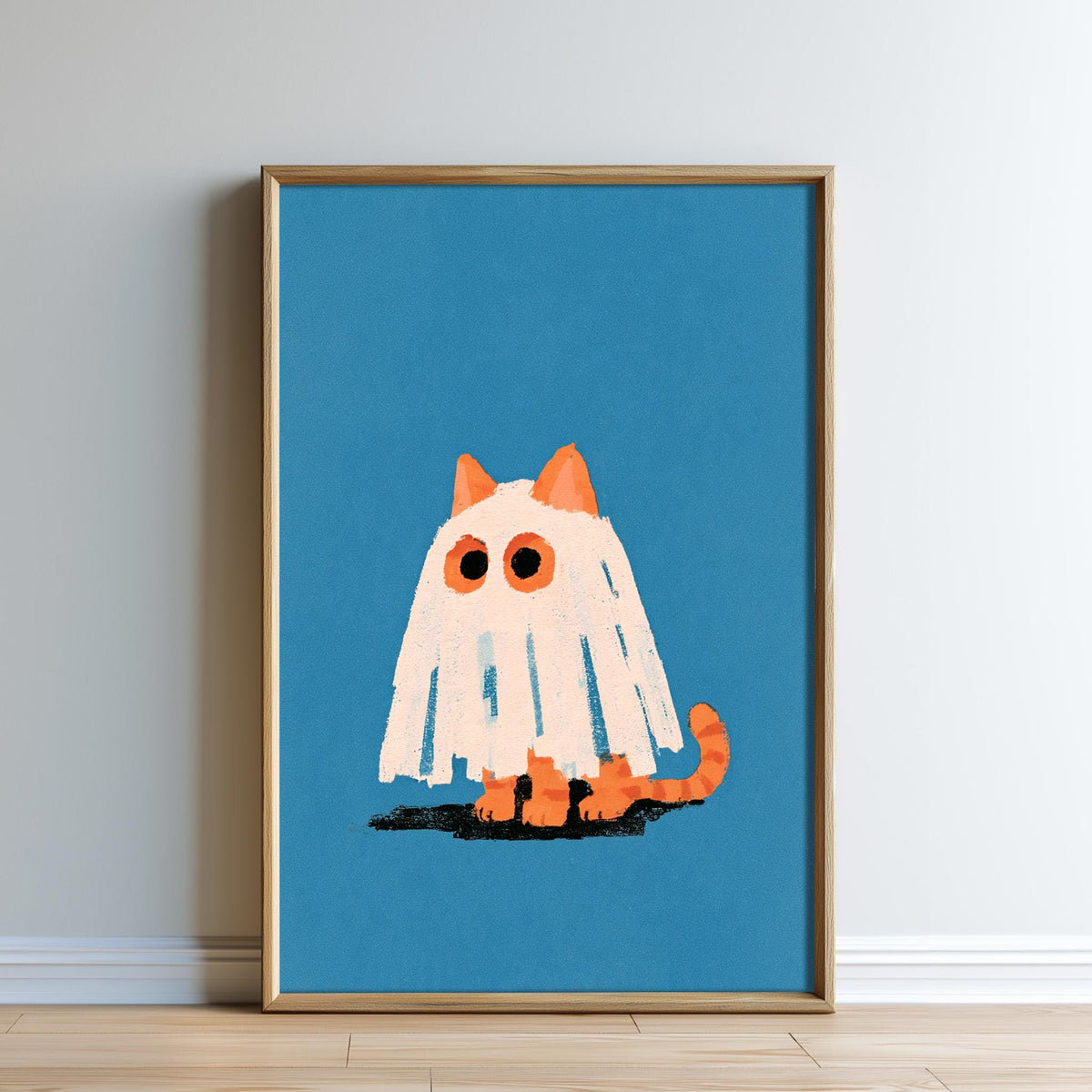 a framed illustration of a ghost cat with a white sheet and orange ears, sitting on a blue background.