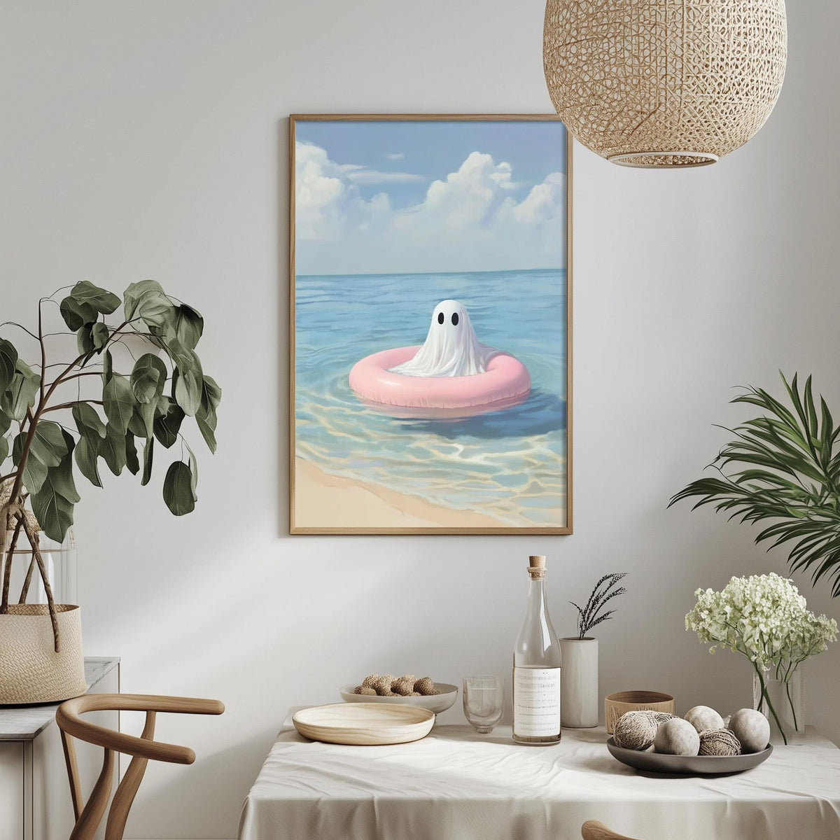 a framed painting of a ghost floating on a pink inner tube in the ocean, surrounded by a beach scene.