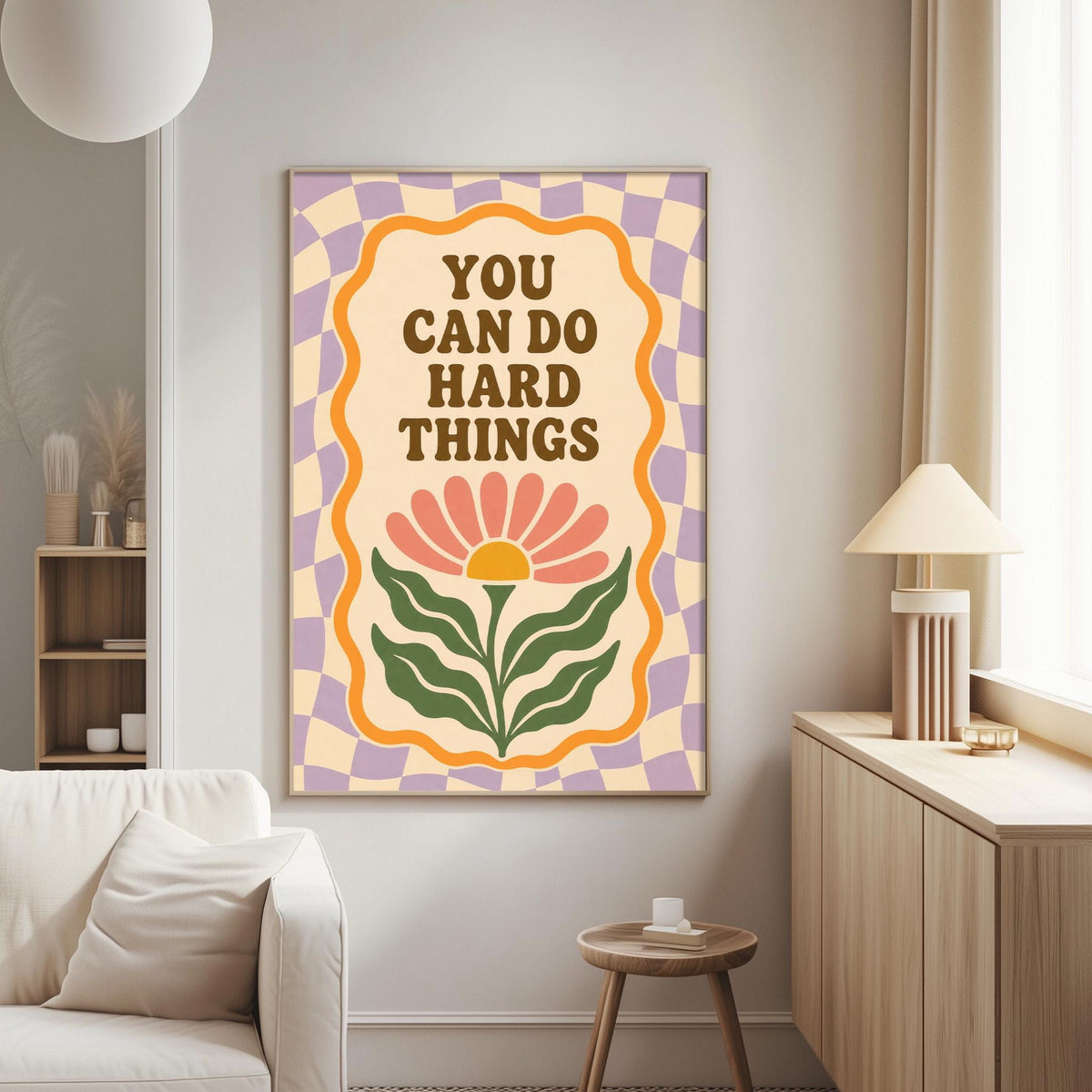 a poster with the text "YOU CAN DO HARD THINGS" on it, hanging on a wall in a living room.