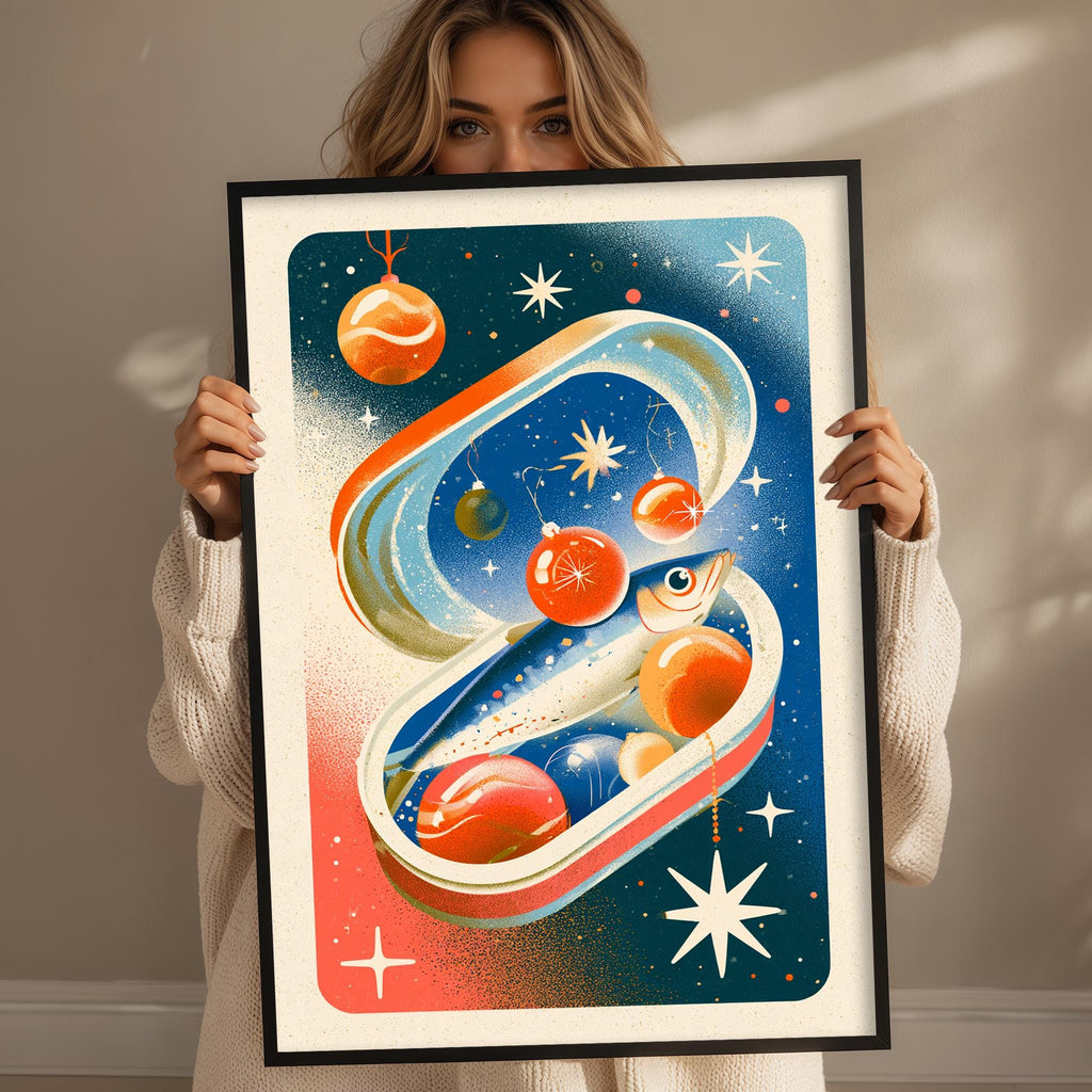 A woman is holding up a framed artwork depicting a whimsical, space-themed scene with various celestial objects and a fish-like creature.