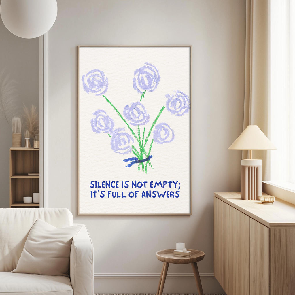 a poster with a floral design and the text "Silence is not empty; it's full of answers" hanging on a wall in a living room.