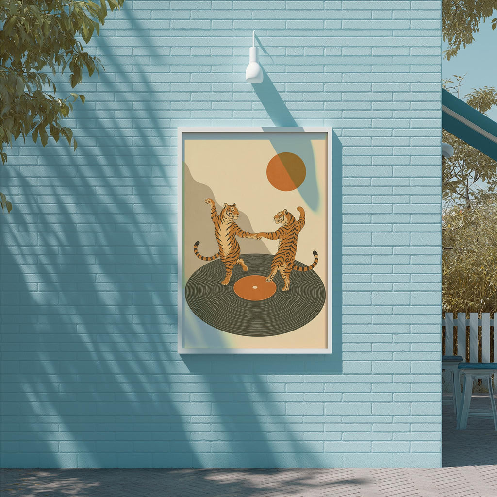 a framed illustration of two dancing tigers on a record player, set against a blue brick wall.
