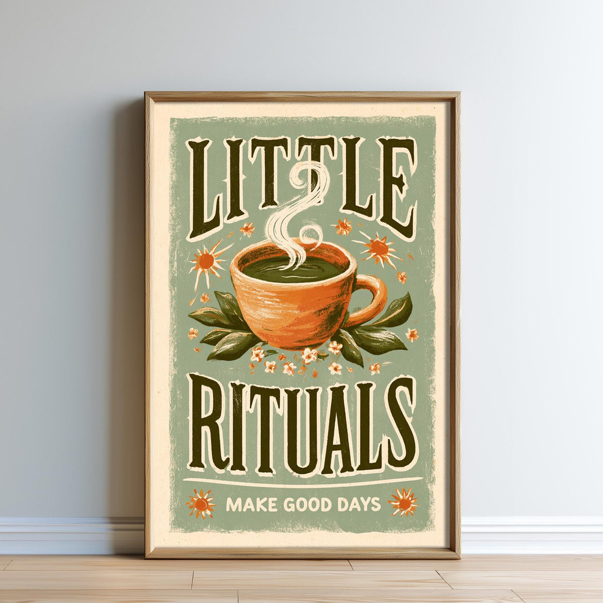 The image is a framed poster with a vintage-style design featuring a cup of tea surrounded by flowers and leaves, along with the text "LITTLE RITUALS" and "MAKE GOOD DAYS".