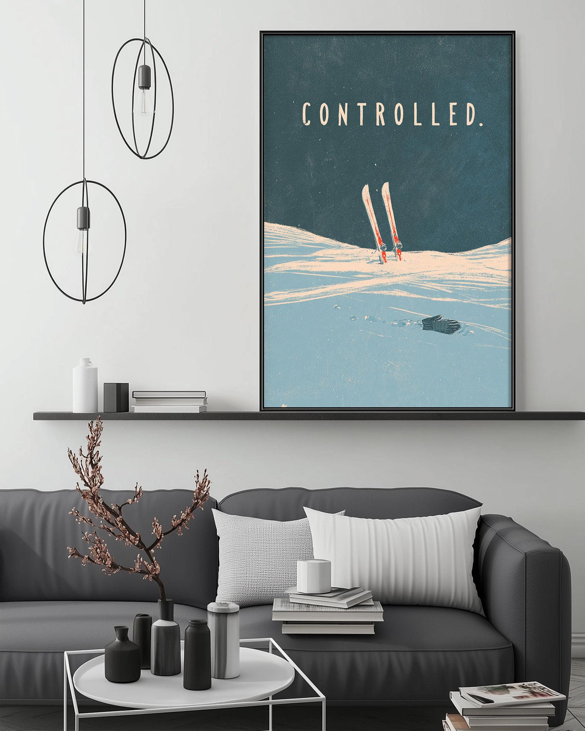 a cozy living room with a gray couch, a coffee table, and a framed poster of skis on the wall.