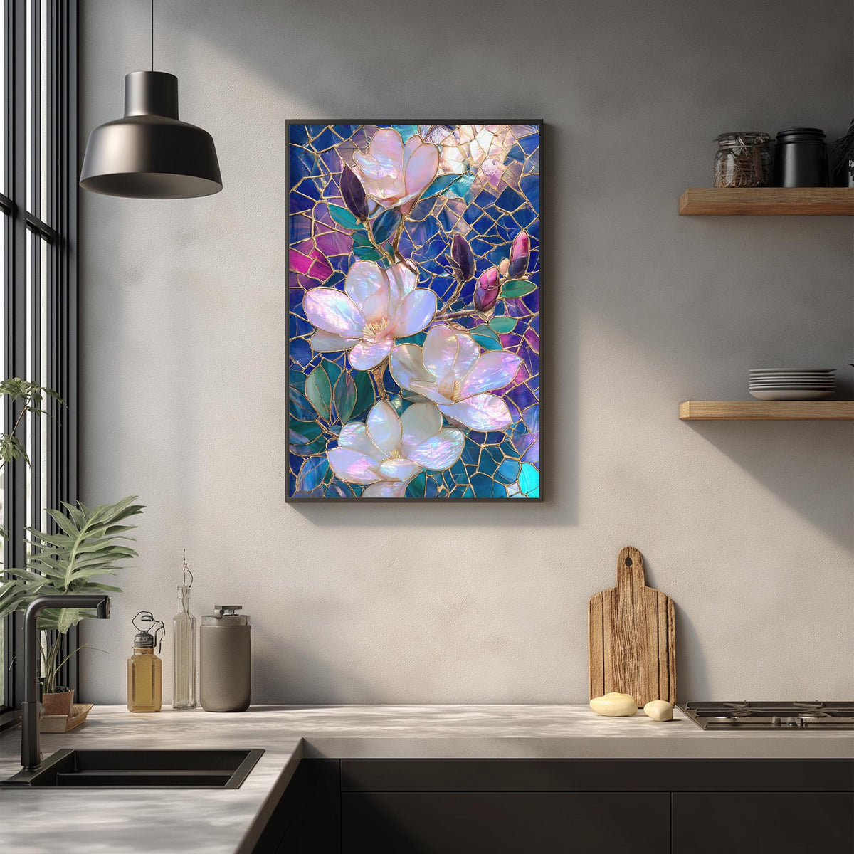 a kitchen counter with a framed stained glass artwork of pink and purple flowers hanging above it. The counter also has various kitchen items such as a cutting board, a soap dispenser, and a bottle.