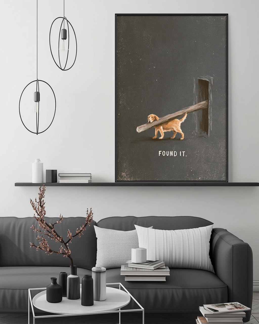a cozy living room with a gray couch, a coffee table, and a large framed artwork depicting a dog carrying a wooden stick with the text "FOUND IT."