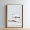 A framed image of a swan floating on a body of water, with the text "FLOAT ON" above it.