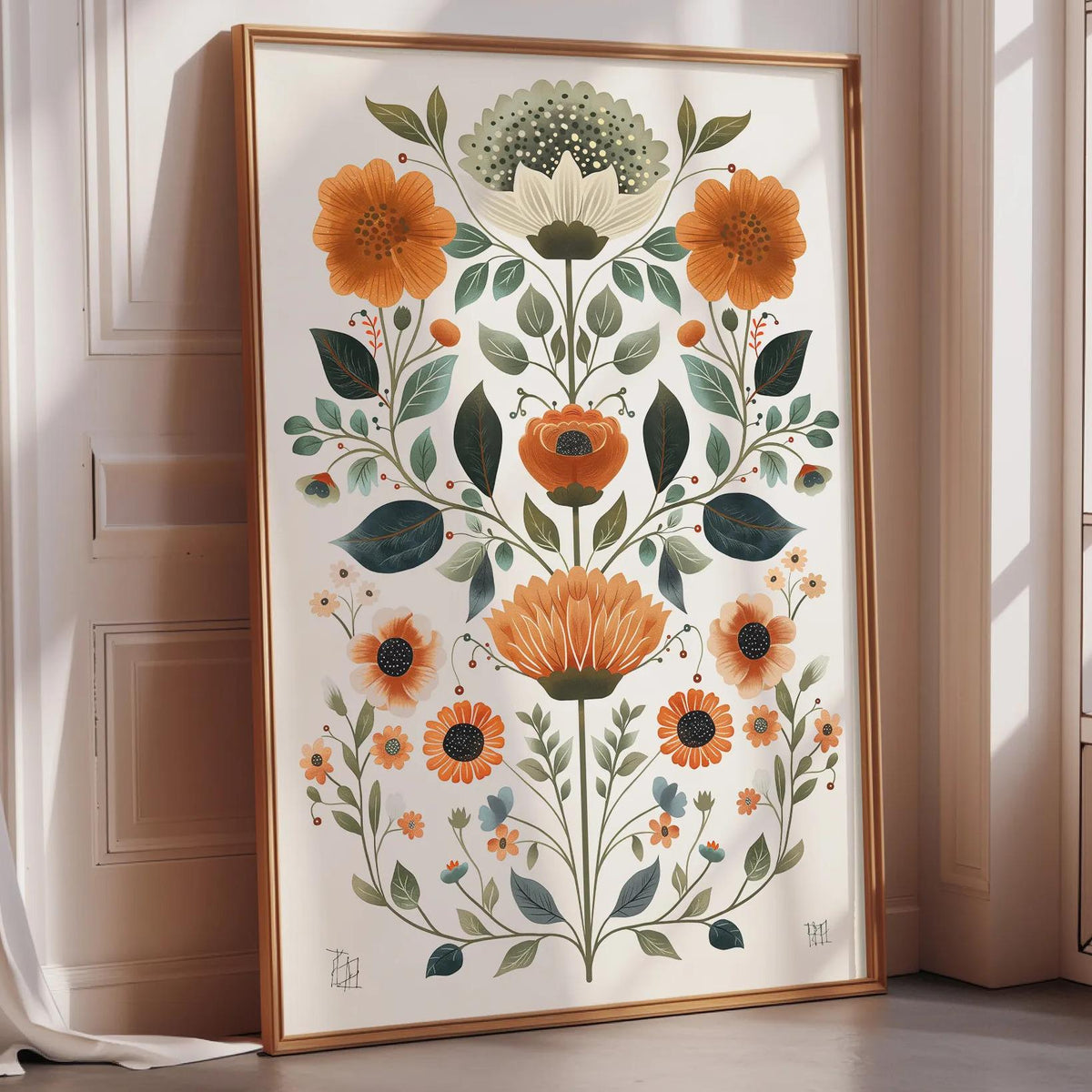 A framed print of a floral design with various flowers and leaves is displayed on a wall in a room with a window.