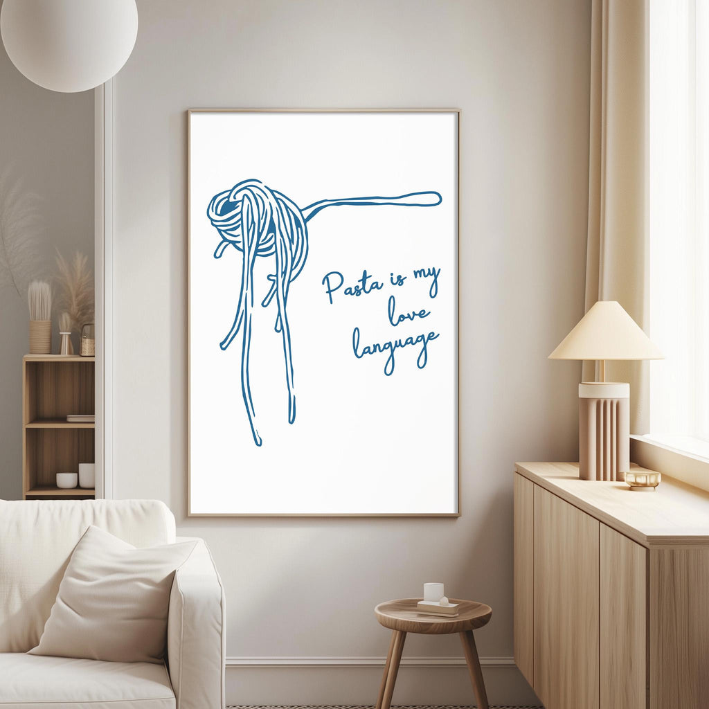 a living room with a white sofa, a wooden side table, and a framed poster on the wall that says "Pasta is my love language".