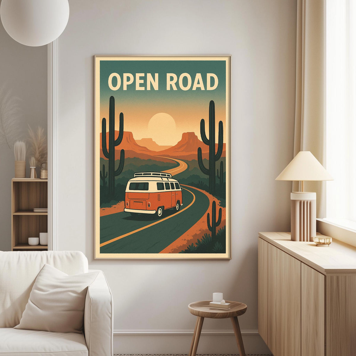 a poster of a red and white van driving on a road through a desert landscape with cacti and mountains in the background, hanging on a wall in a living room.