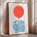 a framed illustration of a person holding a red balloon.