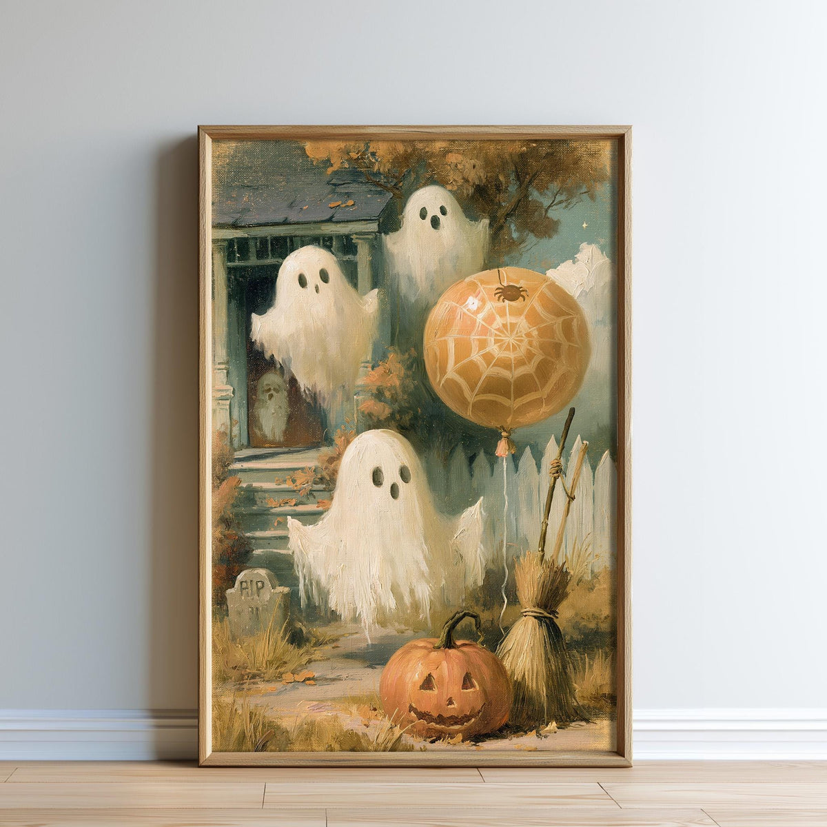 The image is a framed painting depicting a Halloween scene with ghostly figures, a pumpkin, a broom, and a spider web.