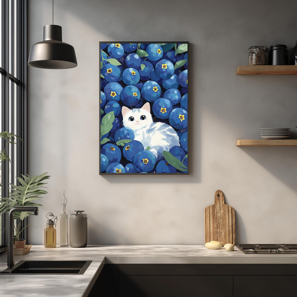 a kitchen counter with various items, including a framed painting of a cat surrounded by blueberries, a wooden cutting board, and a potted plant.