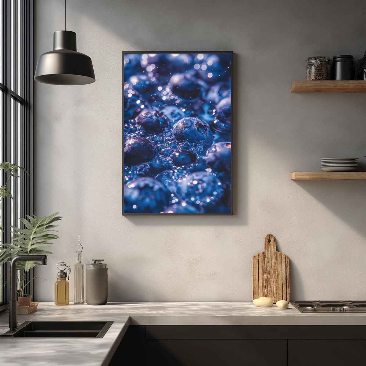 a kitchen counter with various items, including a framed picture of blueberries, a wooden cutting board, and a potted plant.