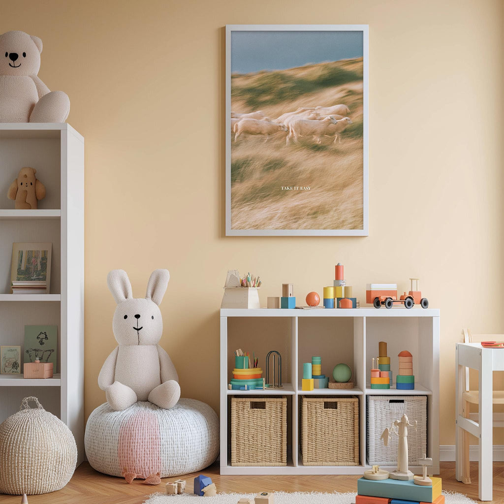 A cozy and colorful children's playroom with a white bookshelf, a plush rabbit, and a toy train set. The room has a warm and inviting atmosphere, with a framed picture of a field and a herd of sheep on the wall.