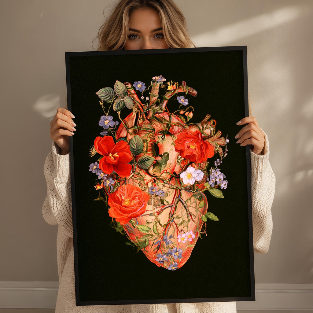 A woman holds a framed artwork depicting a detailed, colorful, and intricate floral design on a black background.