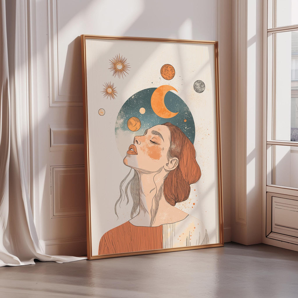 a framed illustration of a woman with her eyes closed, surrounded by celestial elements such as suns, crescents, and planets.