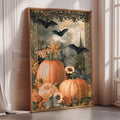 A framed artwork depicting a Halloween-themed scene with pumpkins, flowers, and bats.