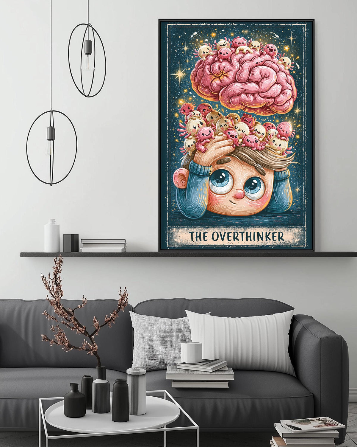 a cozy living room with a gray couch, a coffee table, and a large framed poster of a cartoon character with a pink brain and a pink flower on top of it. The poster is titled "The Overthinker".
