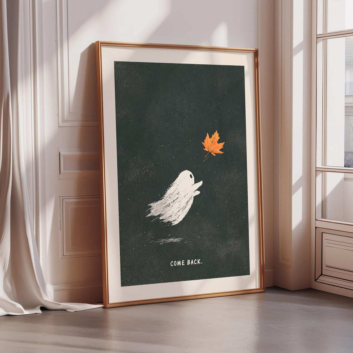 a framed poster with a ghost and a leaf, along with the text "COME BACK."
