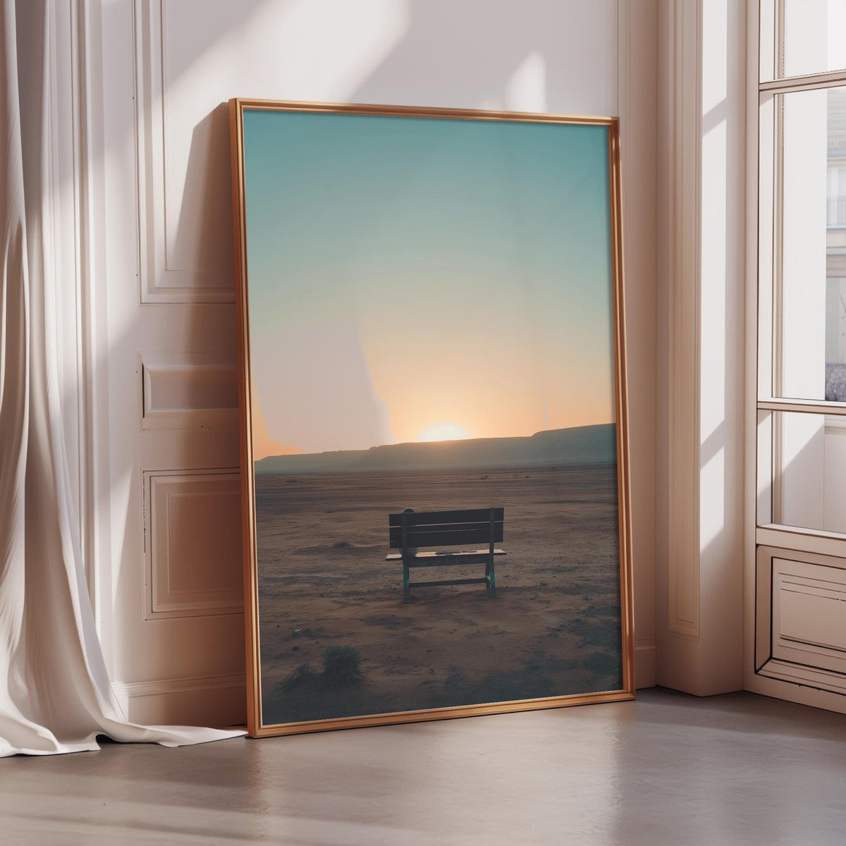 A large framed picture depicting a serene desert landscape at sunset, with a solitary bench in the foreground.