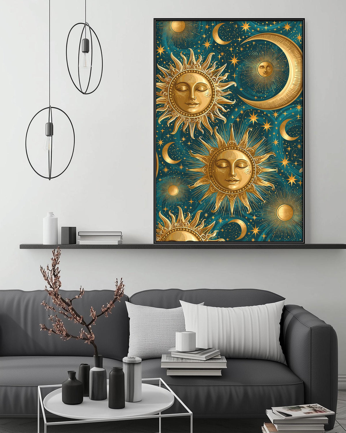 a large framed artwork depicting a night sky with suns, crescents, and stars, hanging above a gray couch in a living room setting.