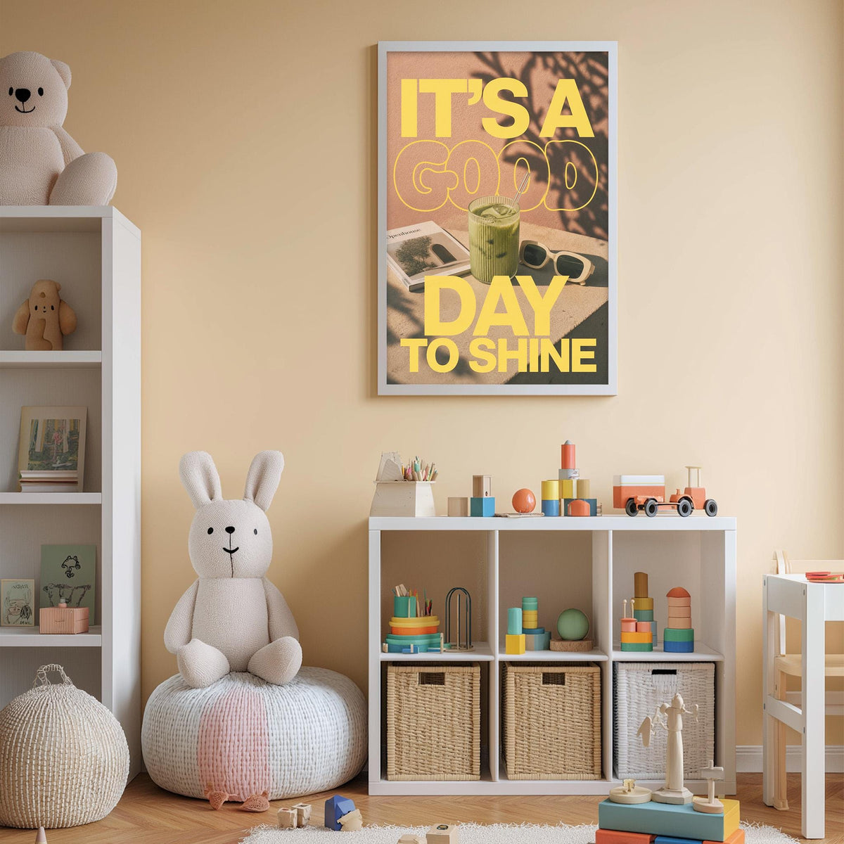 A child's bedroom with a white bookshelf, a stuffed rabbit, and a colorful toy box filled with toys. Above the bookshelf is a framed poster with the text "IT'S A GOOD DAY TO SHINE".