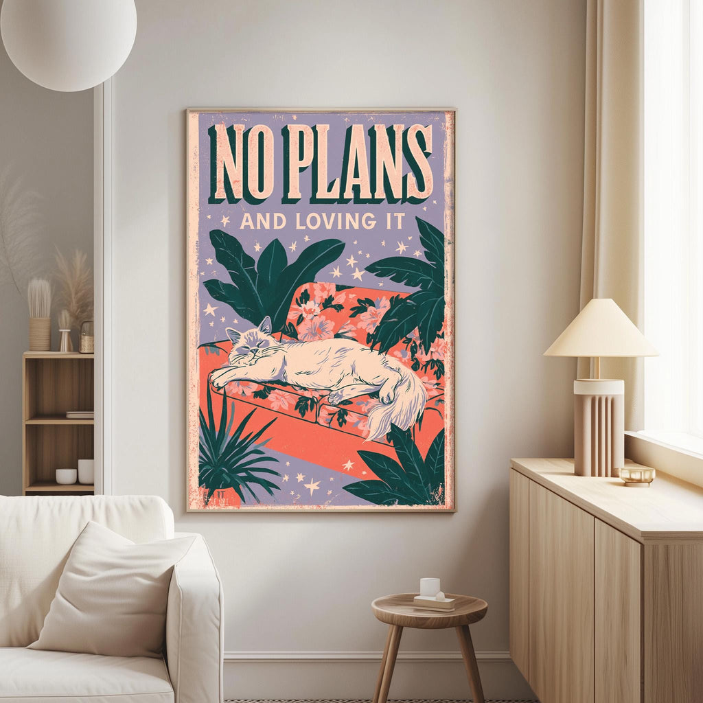 a poster with a cat and tropical plants hanging on a wall in a living room.