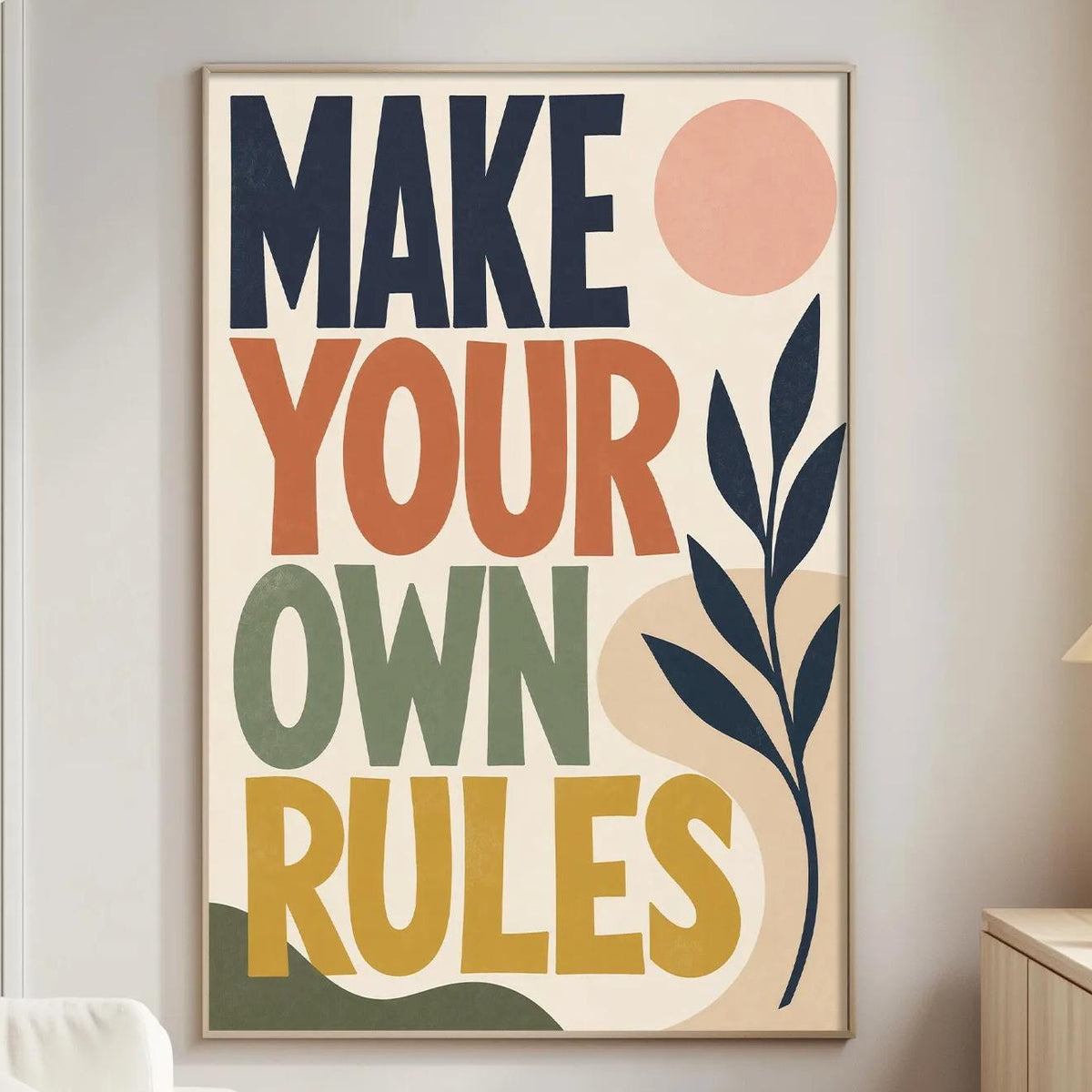 a poster with the text "MAKE YOUR OWN RULES" displayed on a wall in a living room setting.