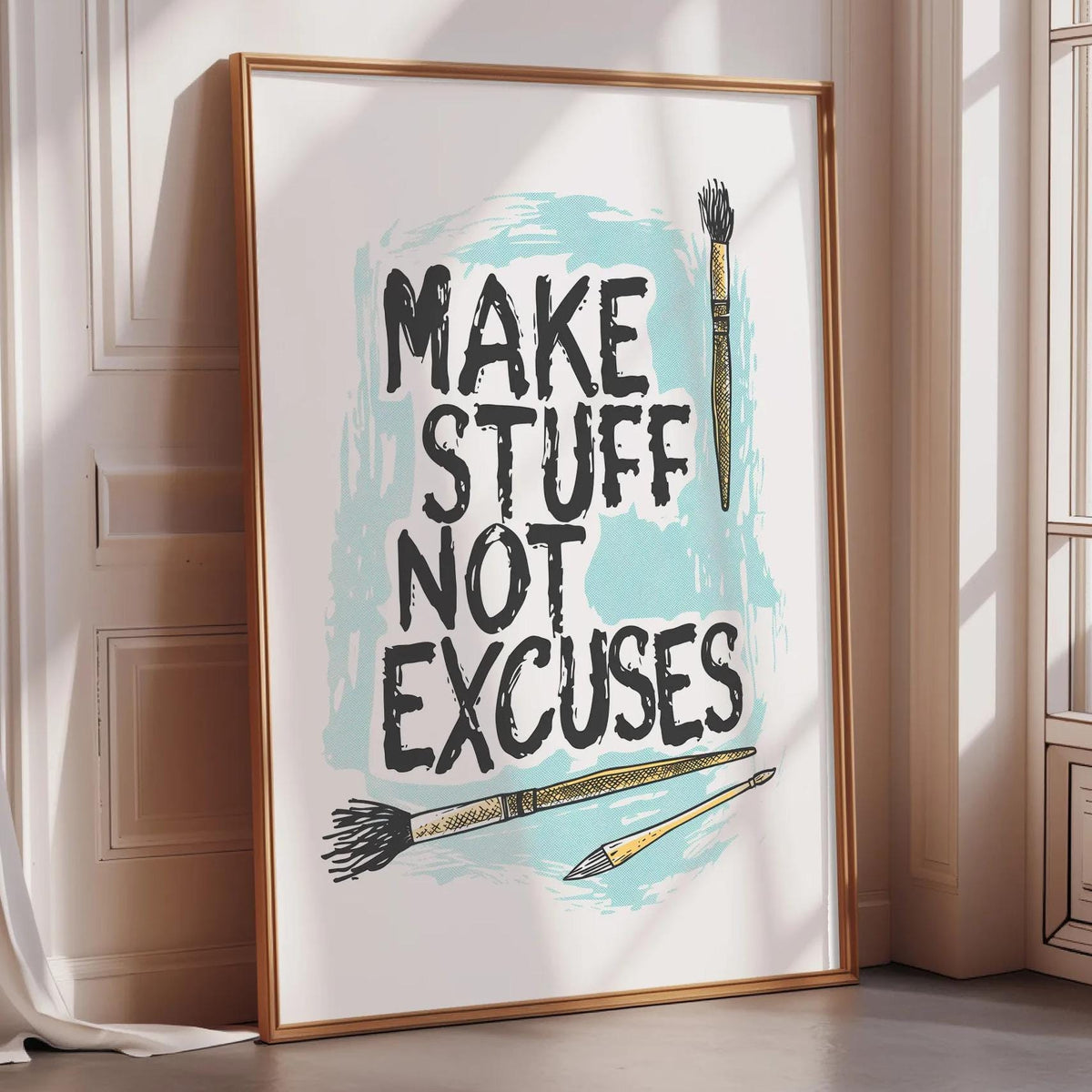 a framed poster with the text "MAKE STUFF NOT EXCUSES" and illustrations of paintbrushes.