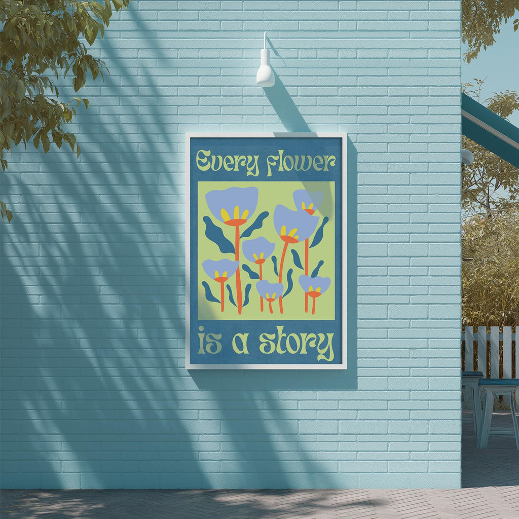 a blue brick wall with a framed poster that displays a colorful illustration of flowers and the text "Every flower is a story".