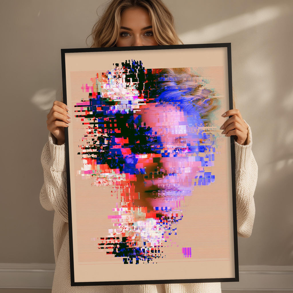 A woman holding a framed digital artwork depicting a colorful, abstract face.