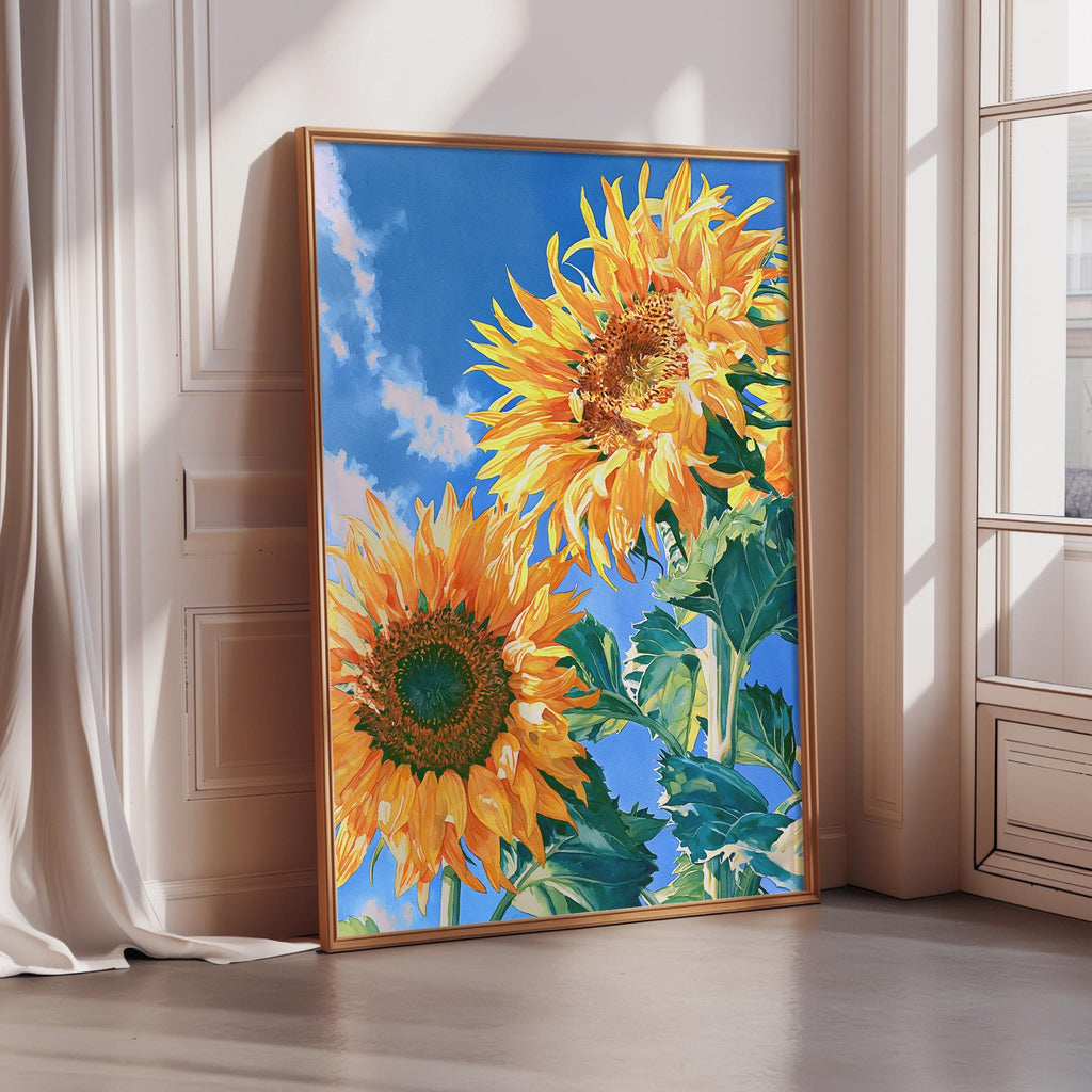 A large framed painting depicting two vibrant sunflowers against a bright blue sky, with a window in the background.