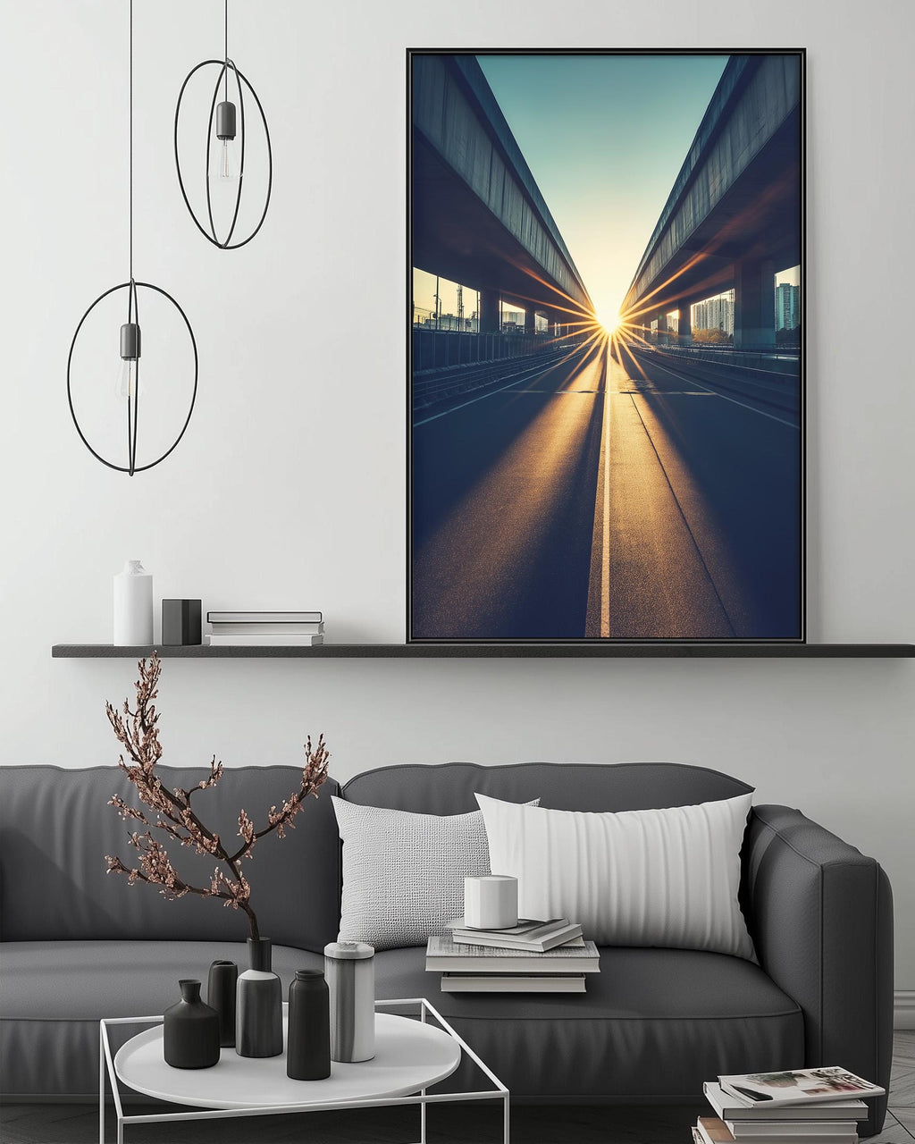 a modern living room with a gray sofa, a coffee table, and a large framed photograph of a city street with a sunlit bridge in the background.