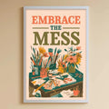 A child's bedroom with a white bookshelf, a stuffed rabbit, and a colorful poster on the wall. The poster has the text "Embrace the mess" and an illustration of a desk with various items on it.