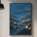 a kitchen counter with various kitchen items, including a cutting board, a bottle, and a vase. Above the counter, there is a framed picture of a mountainous landscape with orange lanterns hanging from the peaks, creating a warm and inviting atmosphere.