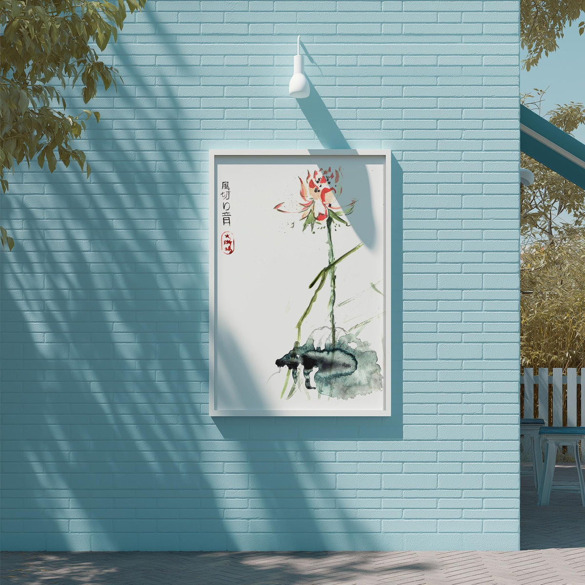 a blue brick wall with a framed painting of a flower hanging on it. The painting is surrounded by a white frame and is set against a light blue background.