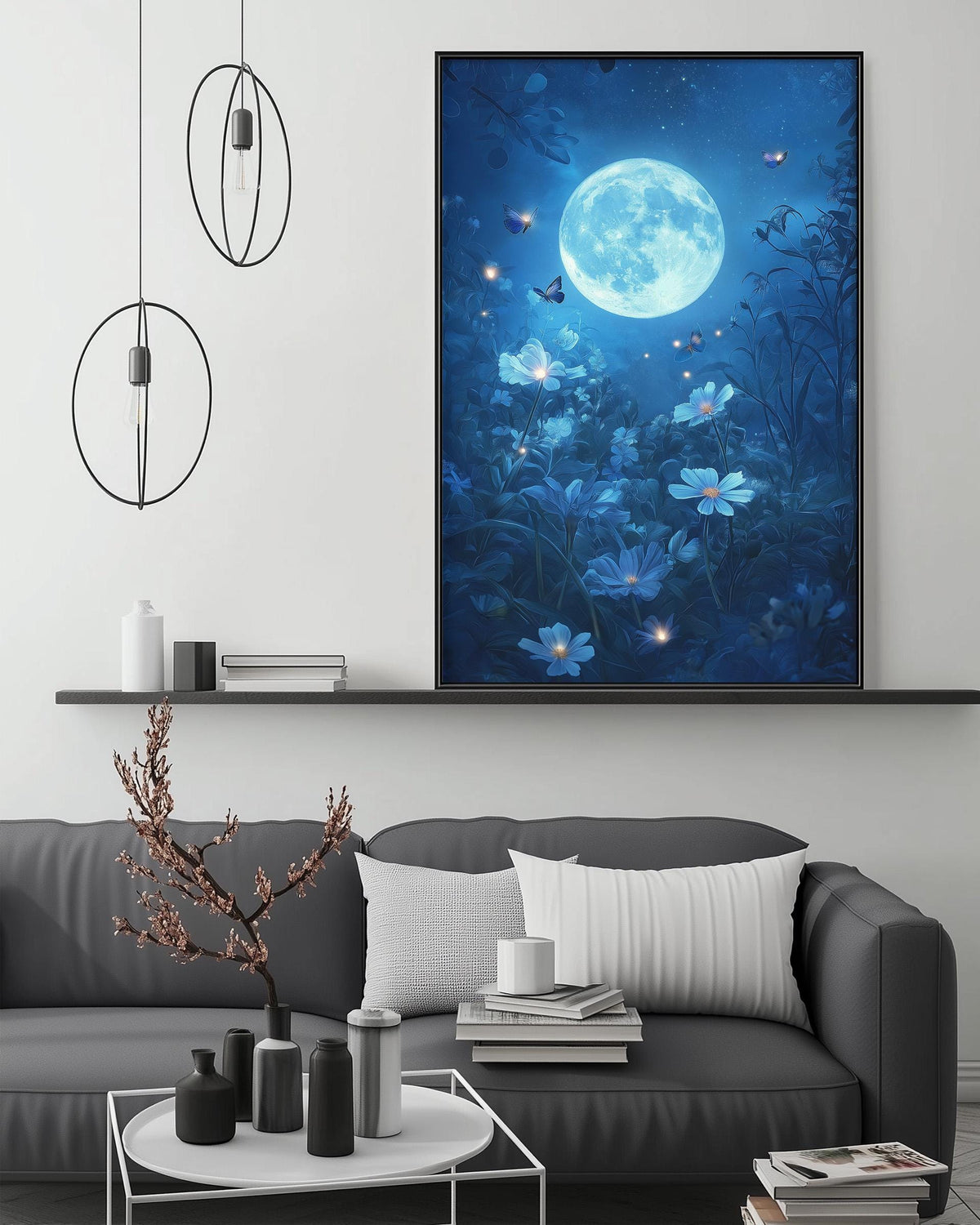 a serene living room with a large framed picture of a moonlit night scene hanging on the wall, featuring a full moon, flowers, and butterflies. The room is furnished with a gray sofa, a coffee table, and various decorative items such as vases and books.