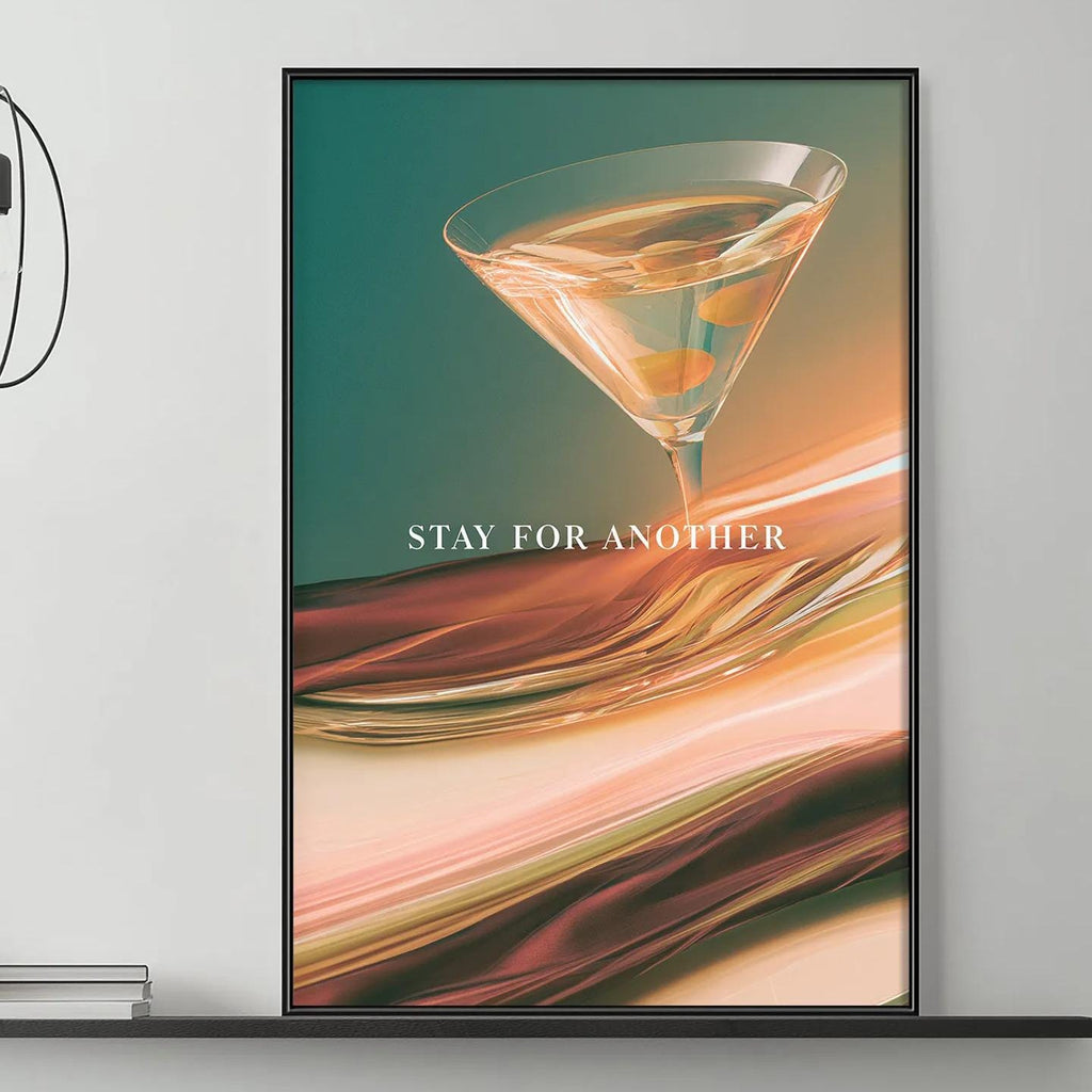 a modern living room with a gray sofa, a coffee table, and a large framed poster of a cocktail glass on the wall.