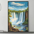 a large framed poster of Iguasu Falls in Argentina hanging on a wall above a gray couch with a coffee table in front of it.