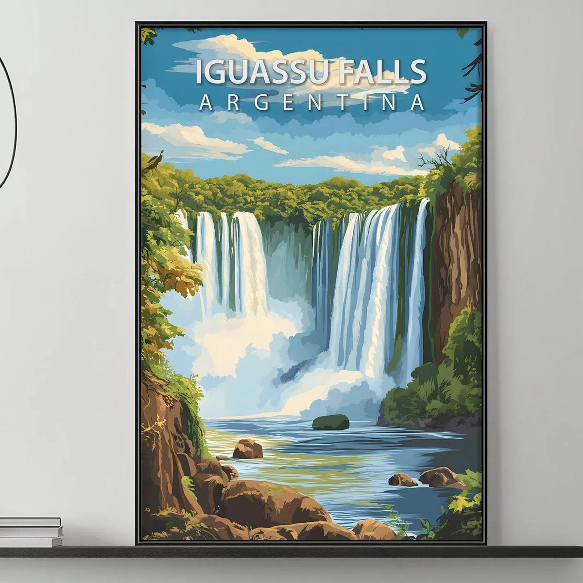 a large framed poster of Iguasu Falls in Argentina hanging on a wall above a gray couch with a coffee table in front of it.