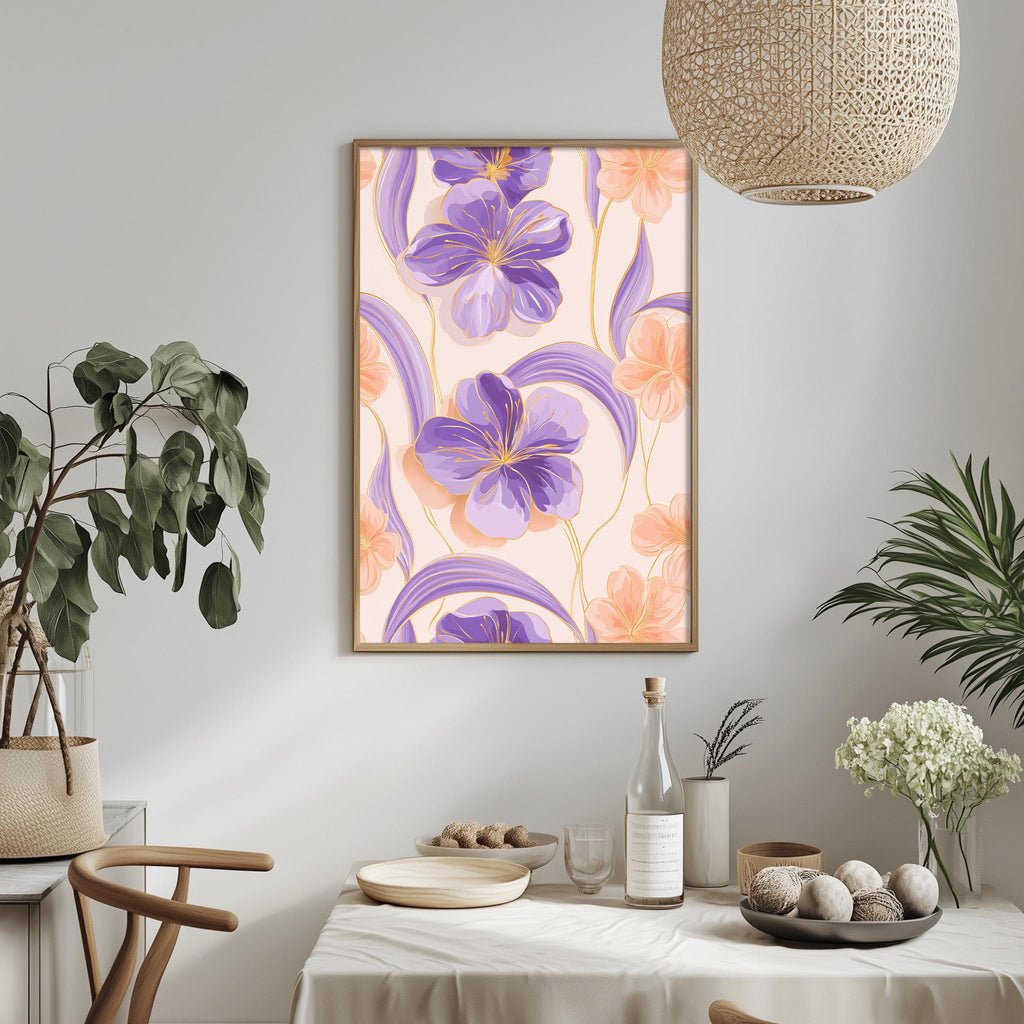 a dining table with a white tablecloth, a bowl of fruit, a bottle, and a vase with flowers. Above the table, there is a framed picture of purple and orange flowers hanging on the wall.